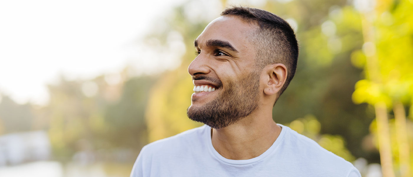 Confident man smiling with ease, showcasing the renewed self-assurance and vitality gained through GAINSWave at Genesis Lifestyle Medicine.