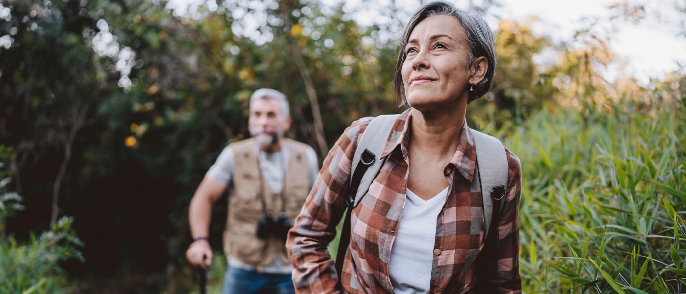 Active couple hiking a scenic trail, representing increased endurance and overall vitality supported by Sermorelin at Genesis Lifestyle Medicine.