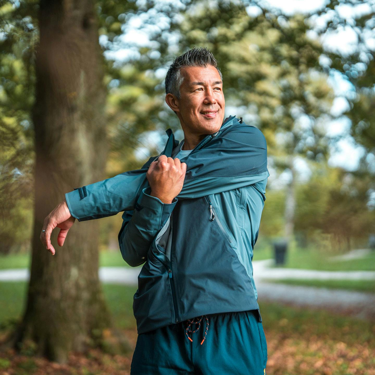 healthy older man stretching outside after NAD+ therapy in Dallas, TX
