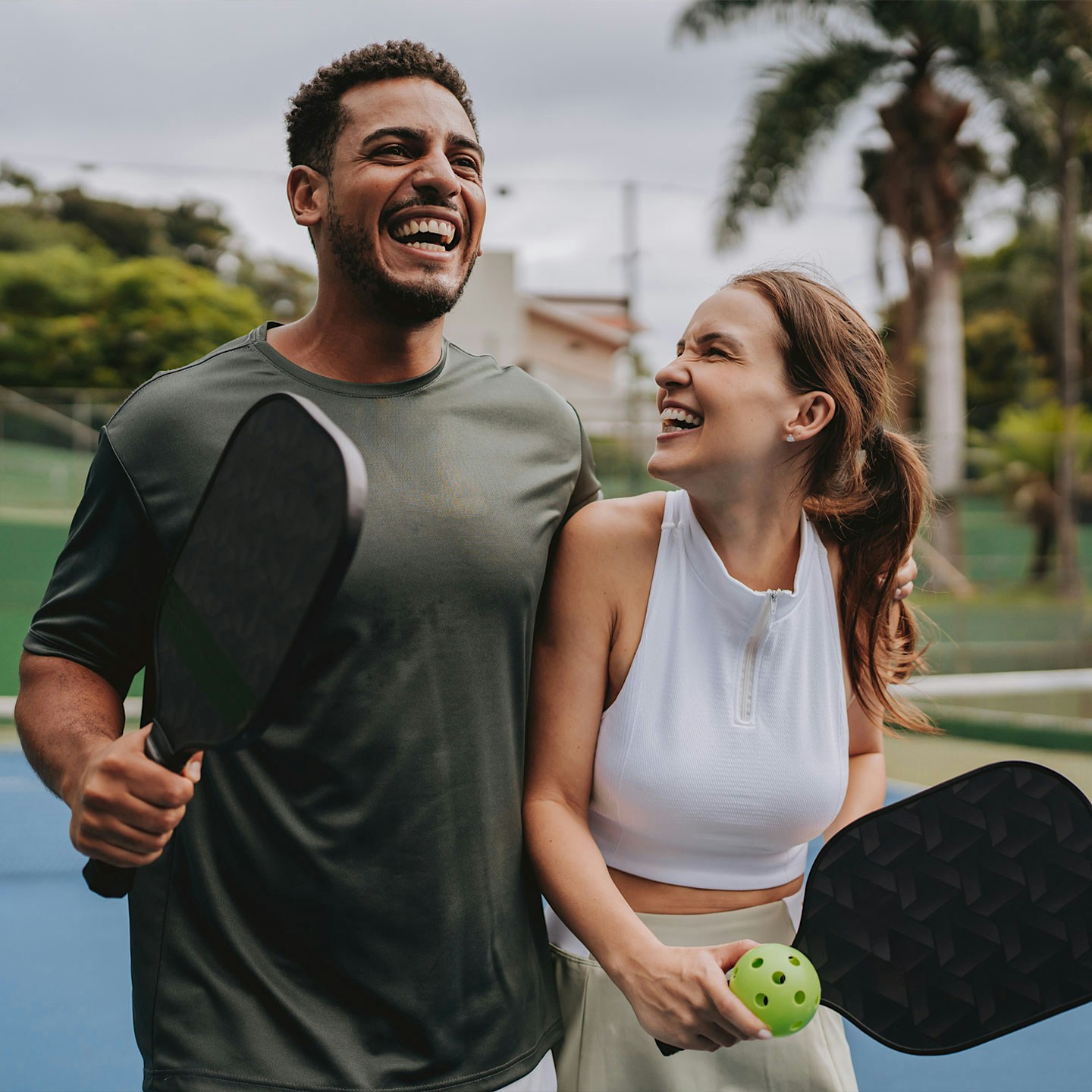 happy couple playing pickleball after NAD+ therapy in Salt Lake City, UT