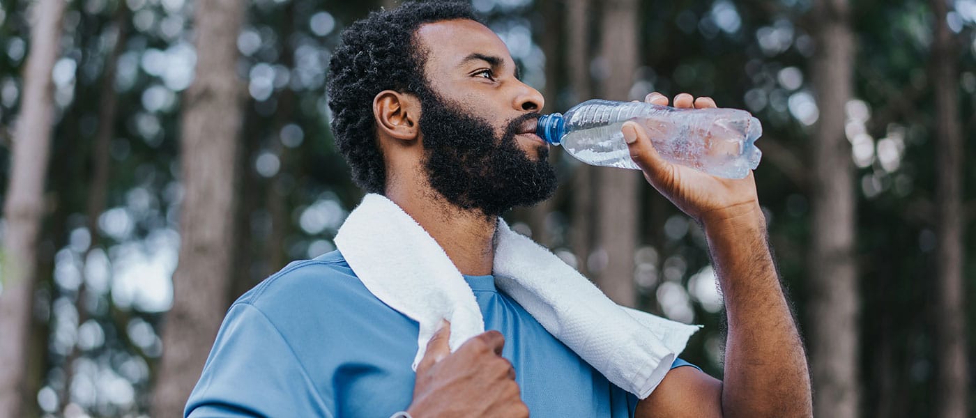 man drinking water after his workout after starting NAD+