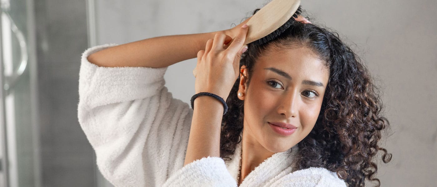woman brushing her hair after taking NAD+