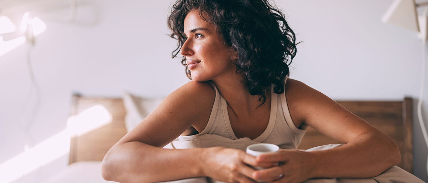 woman in bed happy after taking NAD+