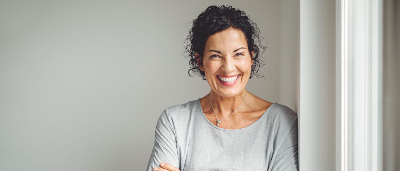 older woman smiling after starting NAD+ therapy