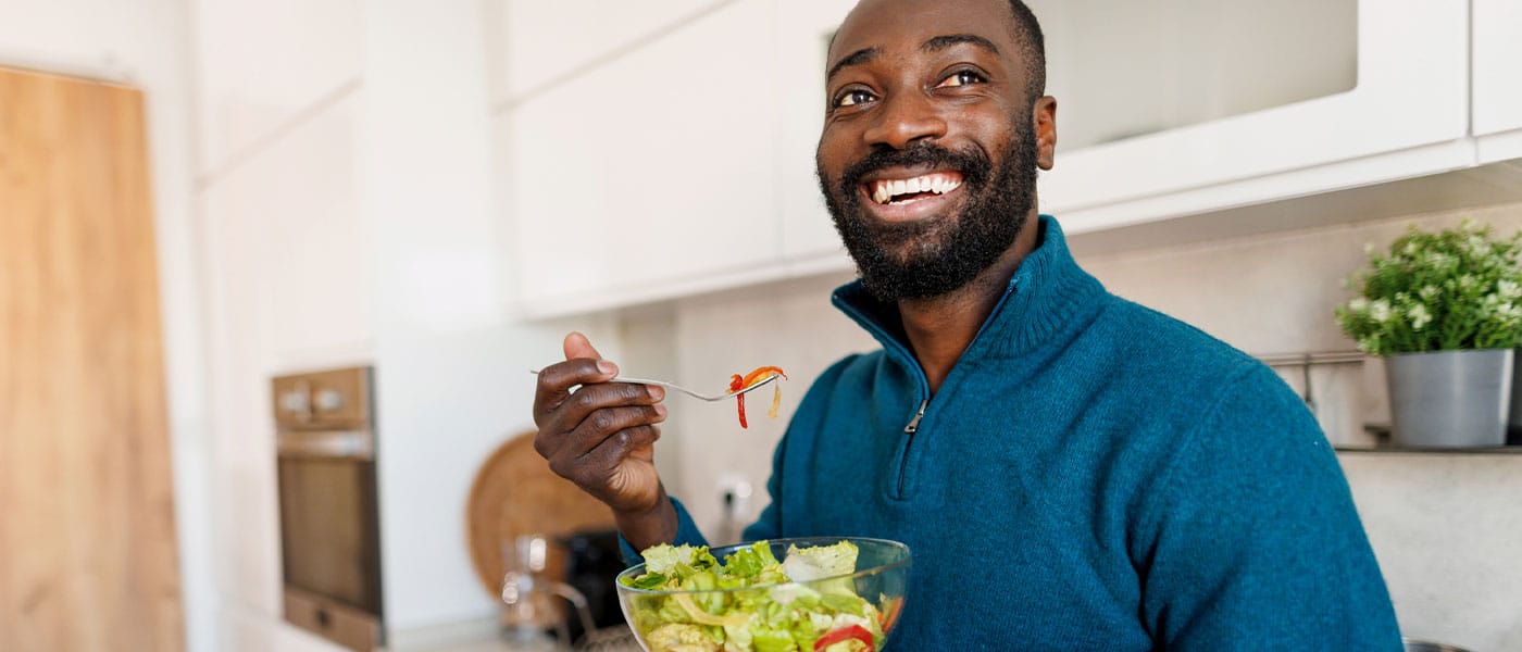 man eating a salad after starting P-Long treatment