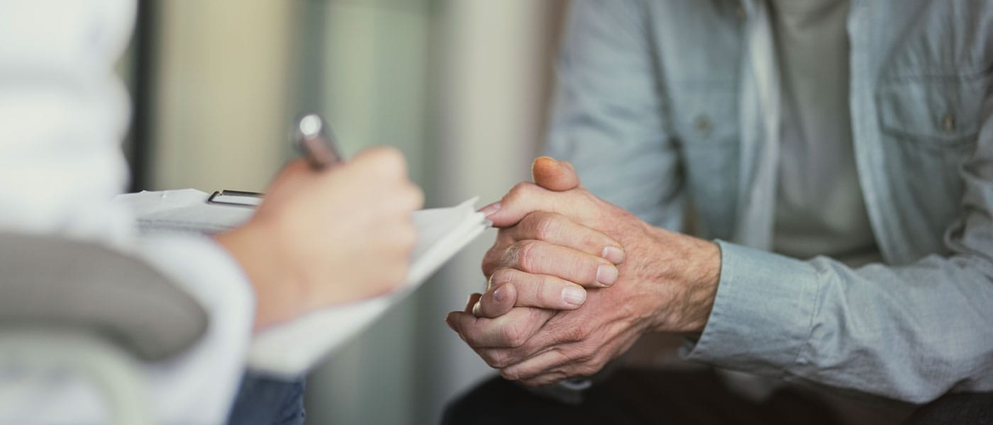 older man discussing P-Long treatment with his doctor