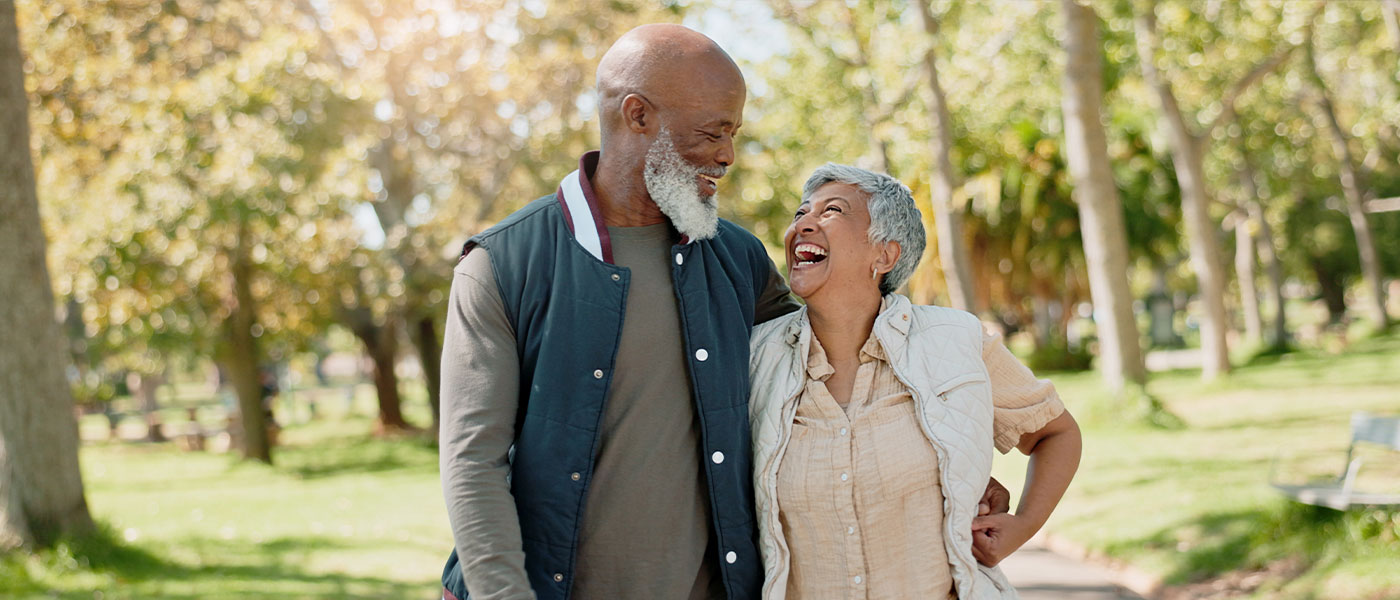 happy older couple walking outside after starting P-Long treatment