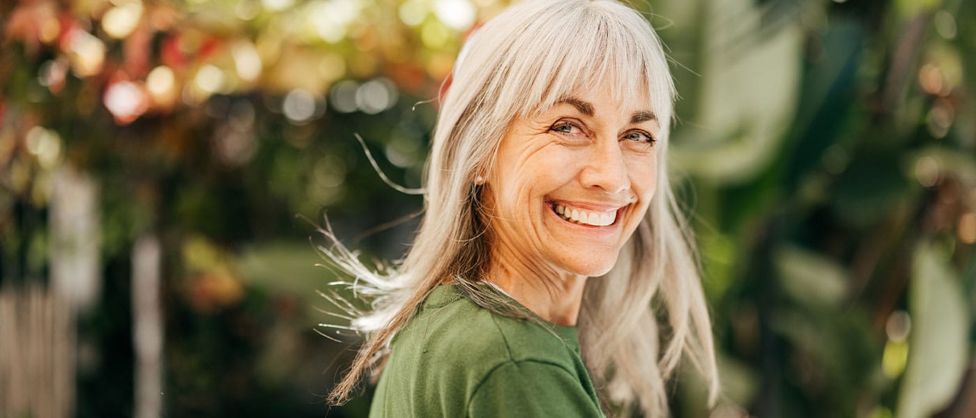 older woman smiling after starting NAD+ therapy