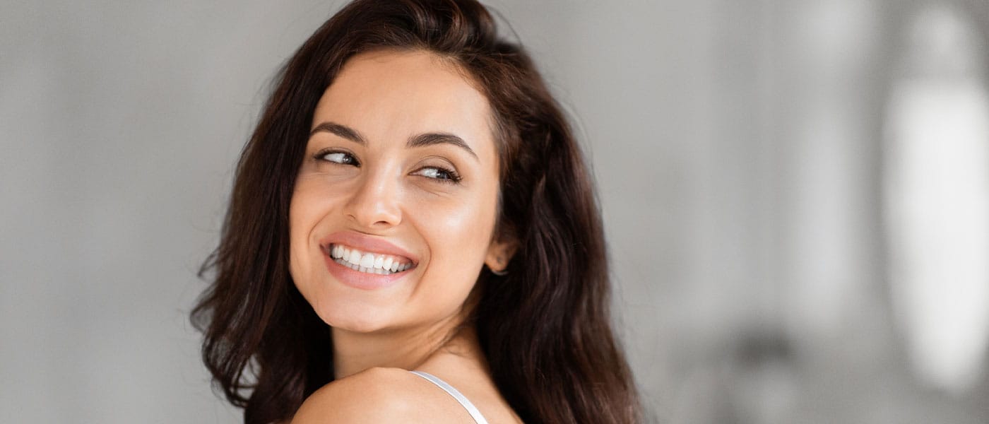 happy woman after starting sermorelin therapy for her skin