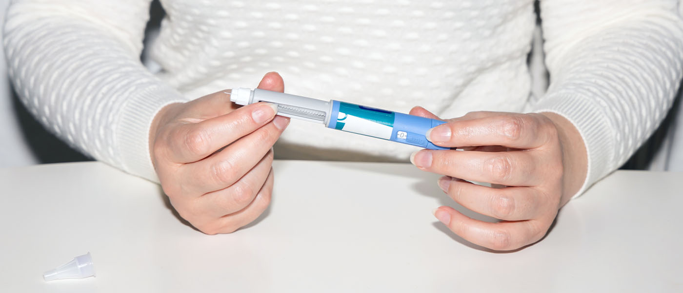 woman holding her sermorelin injection
