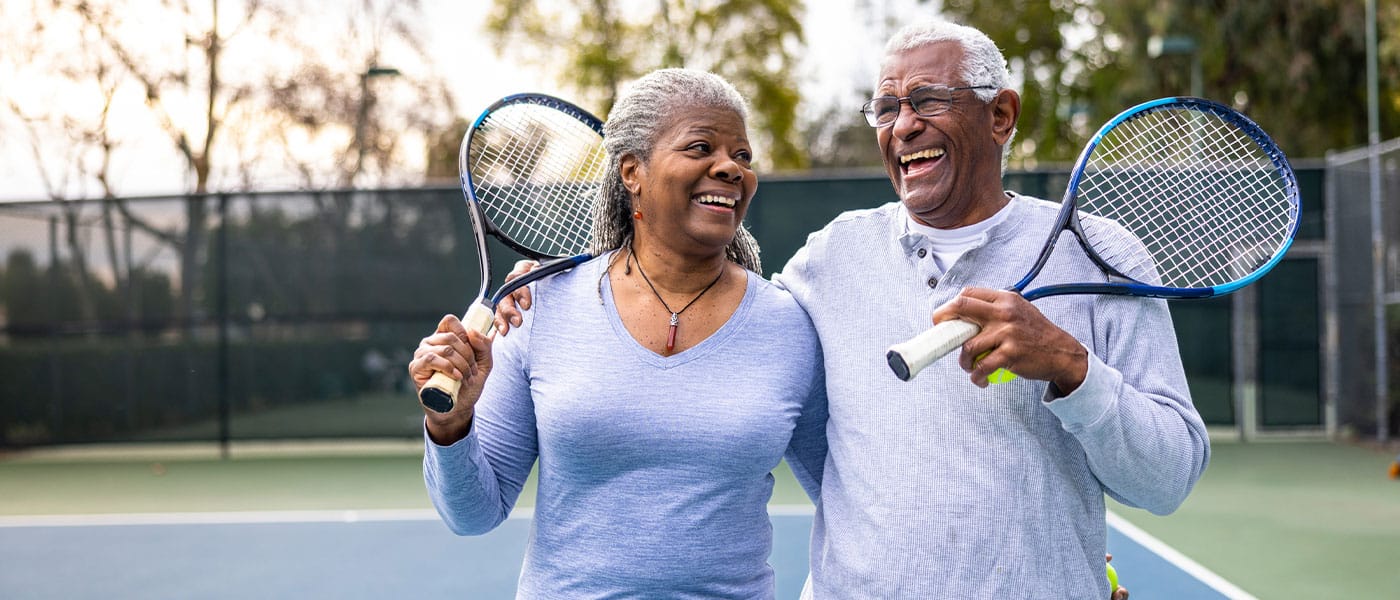 older couple playing tennis together after starting sermorelin therapy