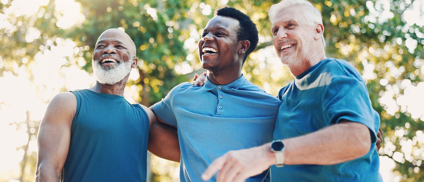 3 men outside together discussing the P-Shot