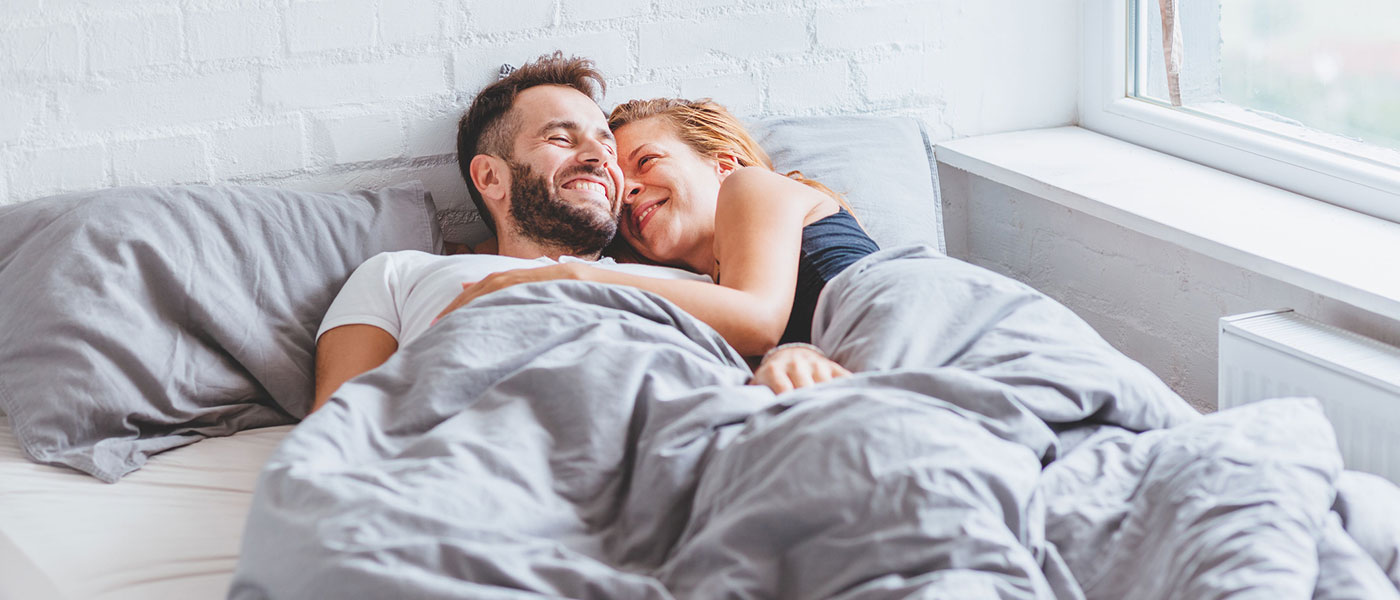 happy couple in bed after starting P-Long treatment