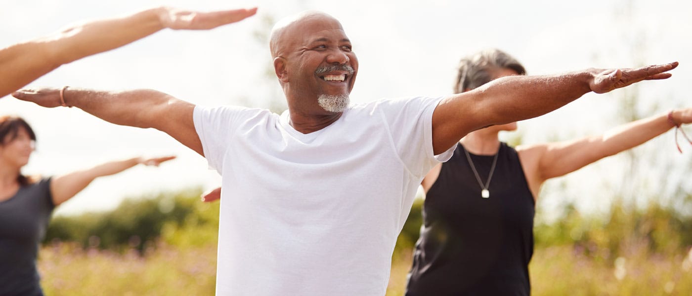 older man doing yoga after starting P-Long treatment