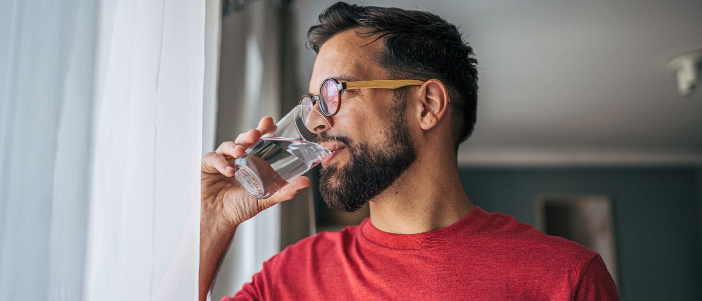 man drinking water after starting testosterone therapy