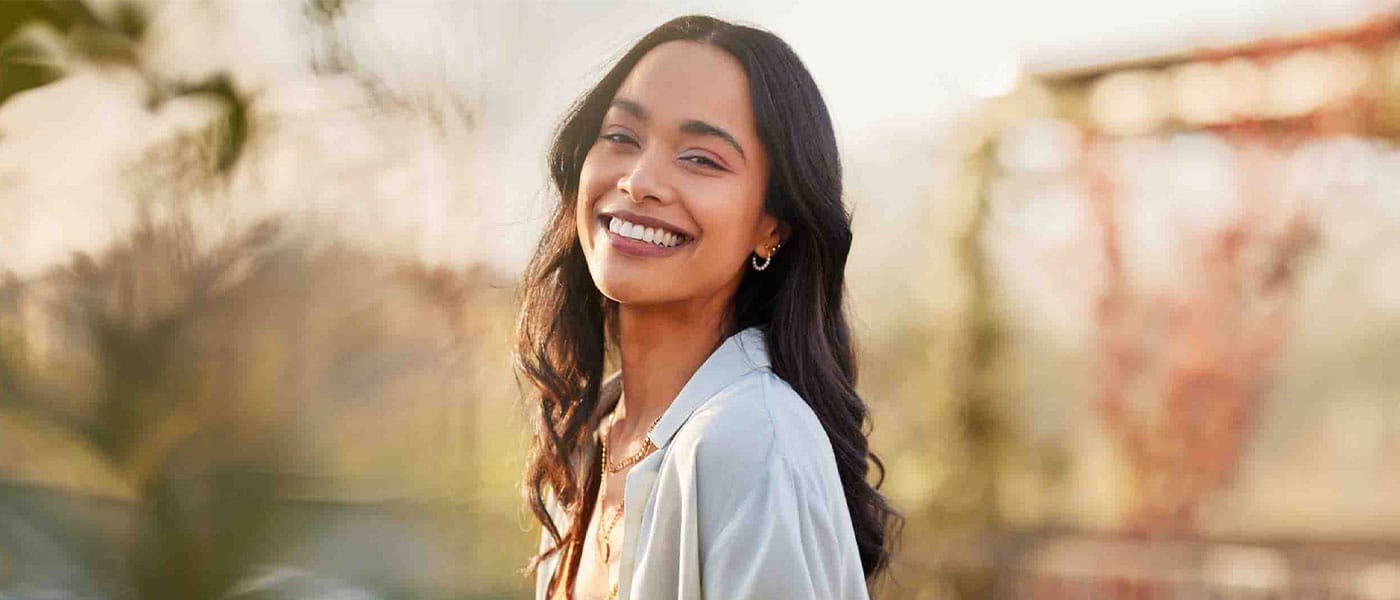 woman smiling after starting hormone therapy