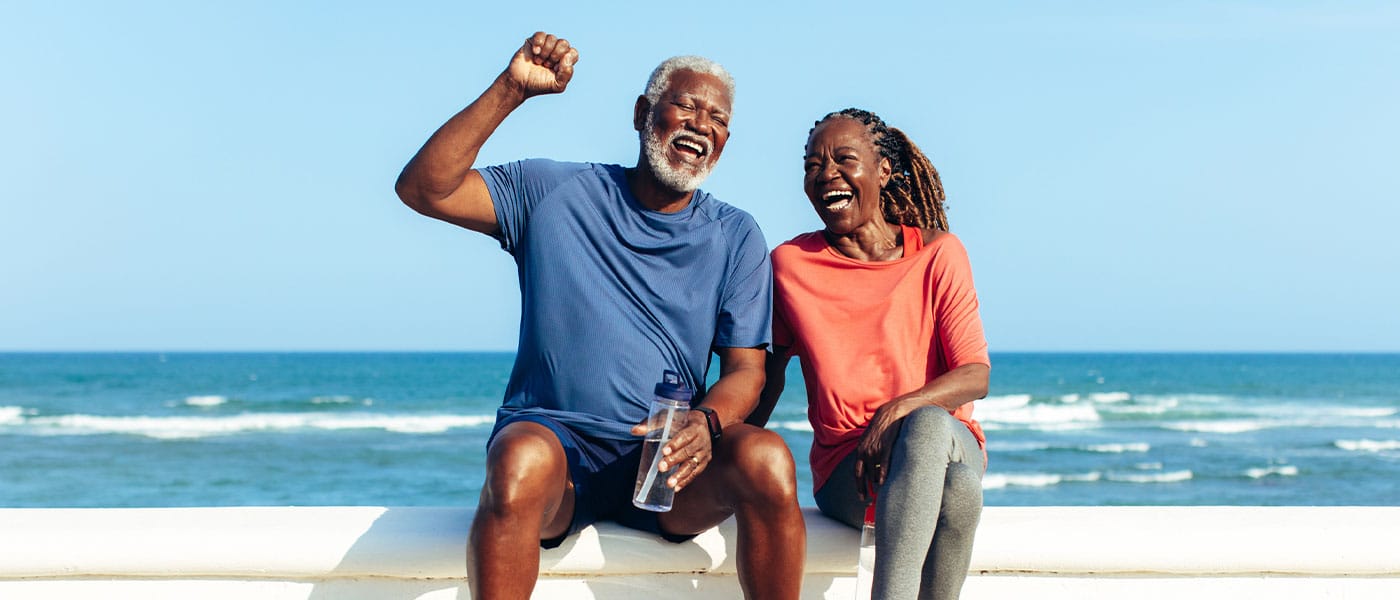 healthy older couple on the beach after starting sermorelin therapy