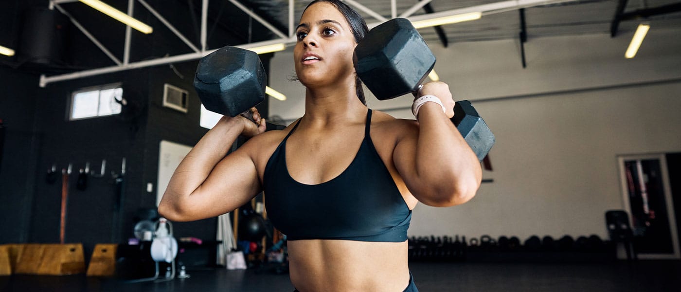 woman lifting weights after starting sermorelin therapy