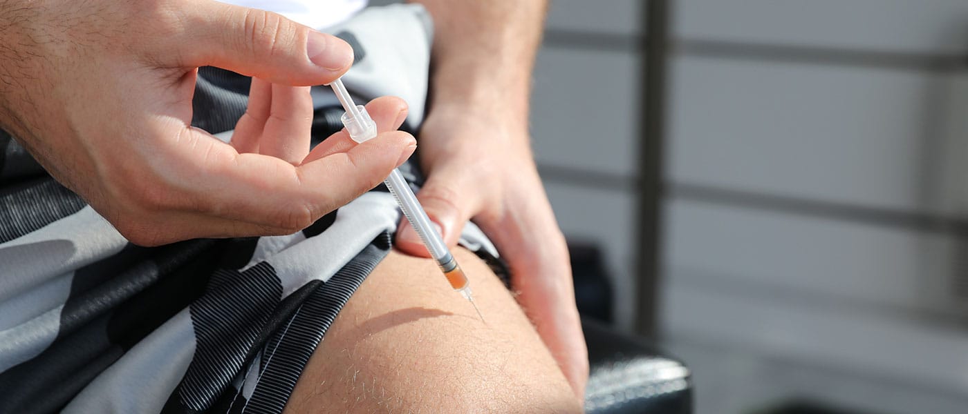 man giving himself a testosterone therapy injection