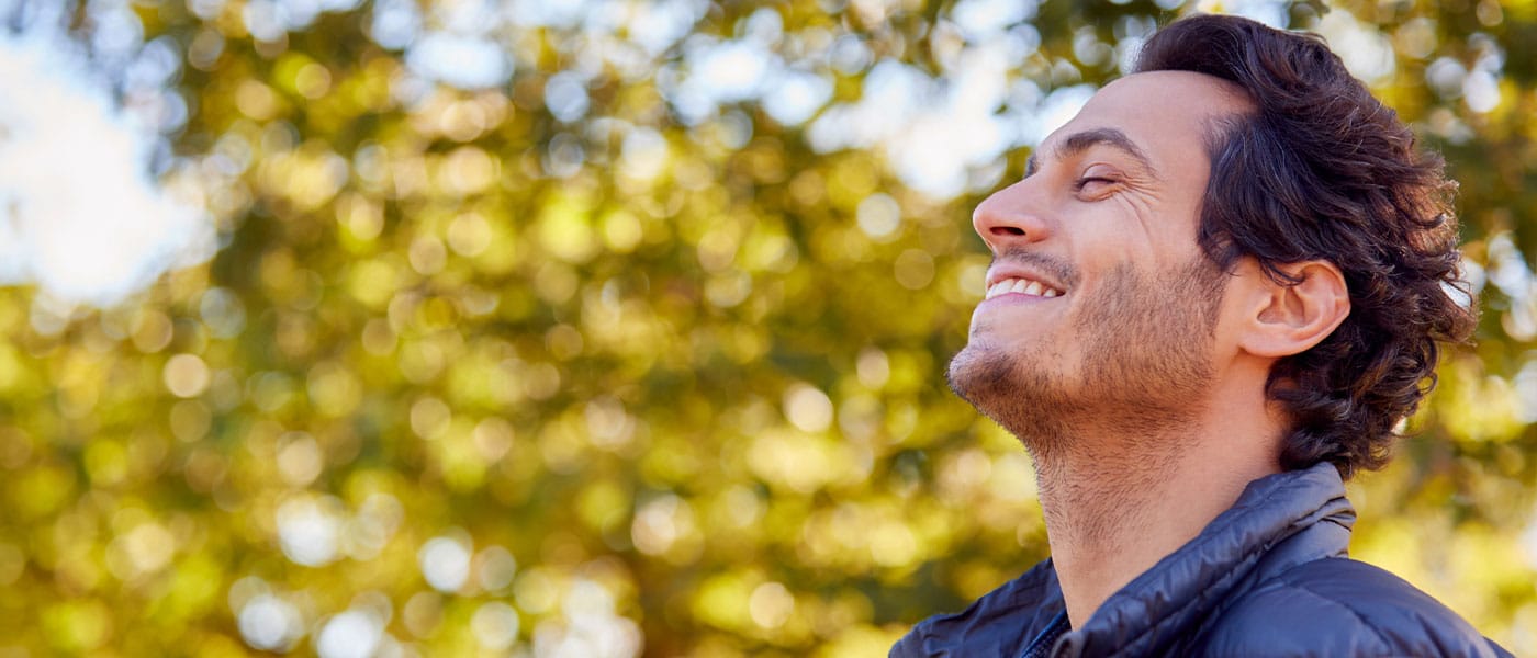 man feeling peaceful outside after starting testosterone therapy