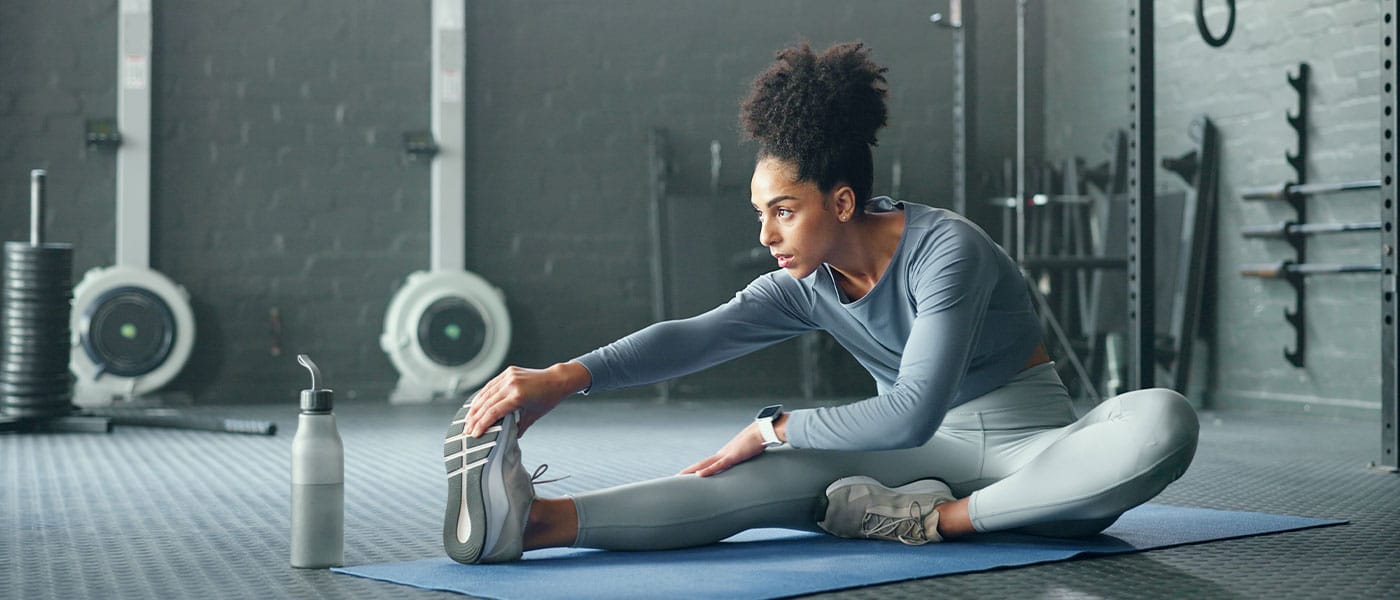 woman stretching after starting hormone therapy
