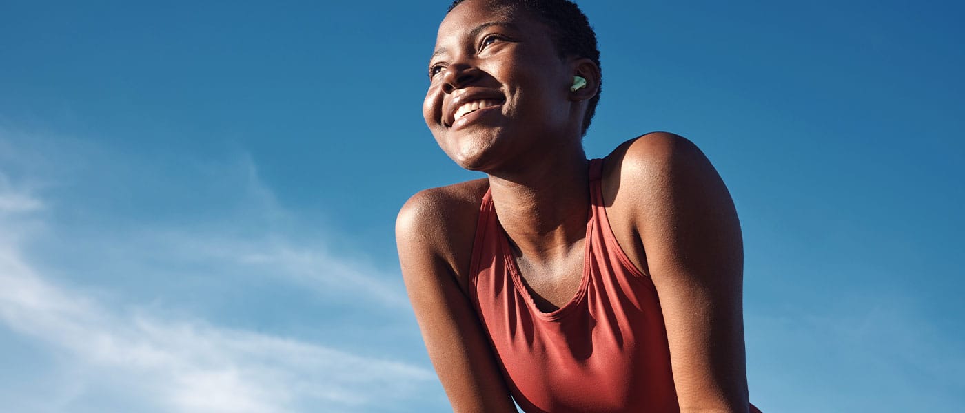 happy woman running outside after starting hormone therapy