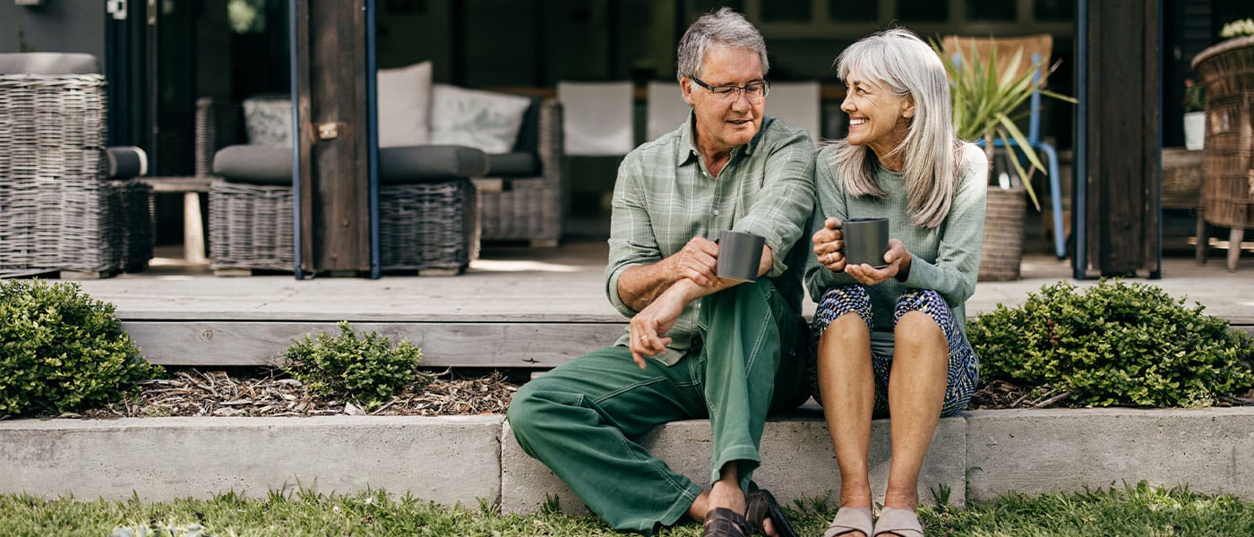 happy older couple sitting outside after starting nad therapy