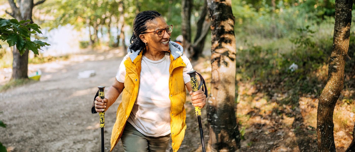 older woman hiking outside after starting NAD therapy