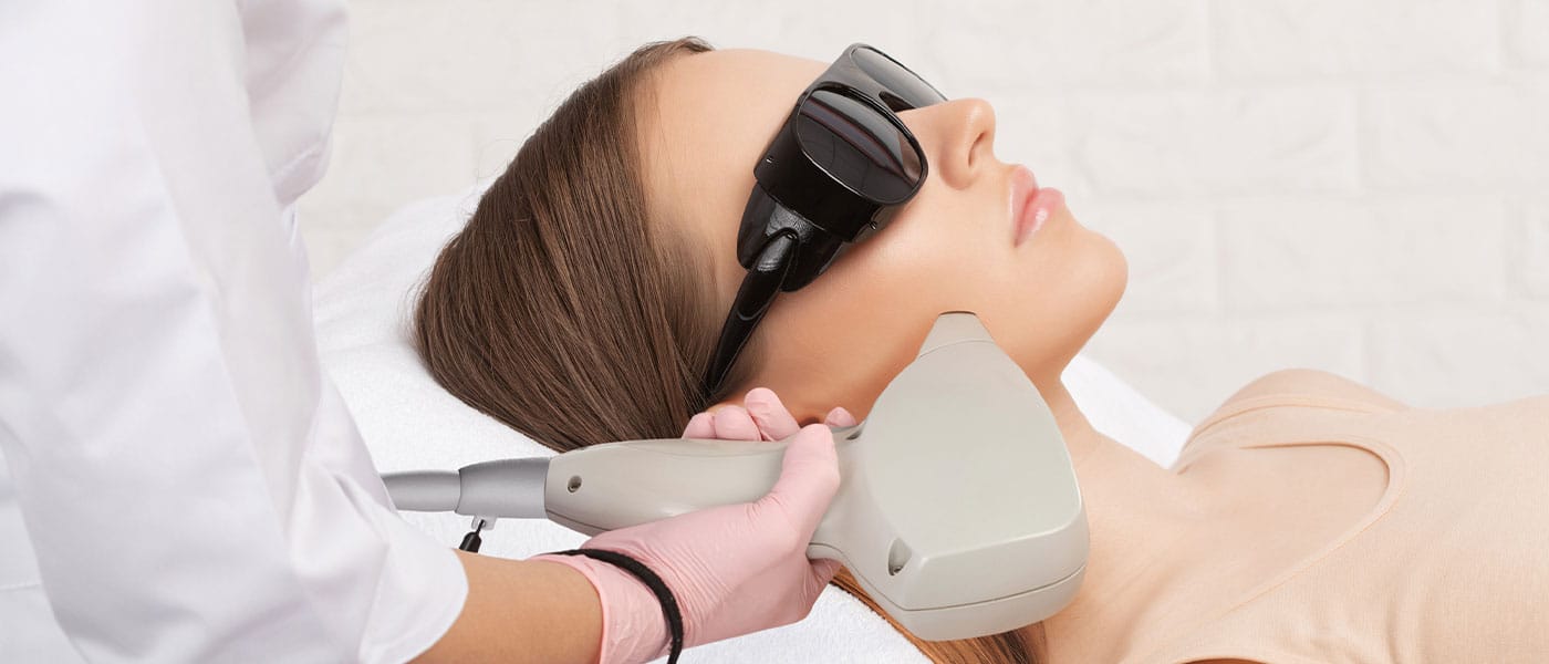 woman receiving laser hair removal on face