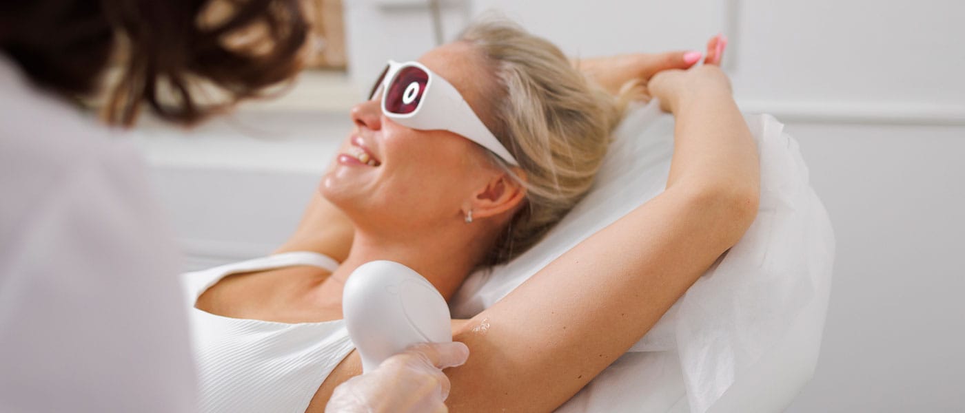 woman receiving laser hair removal on her armpit
