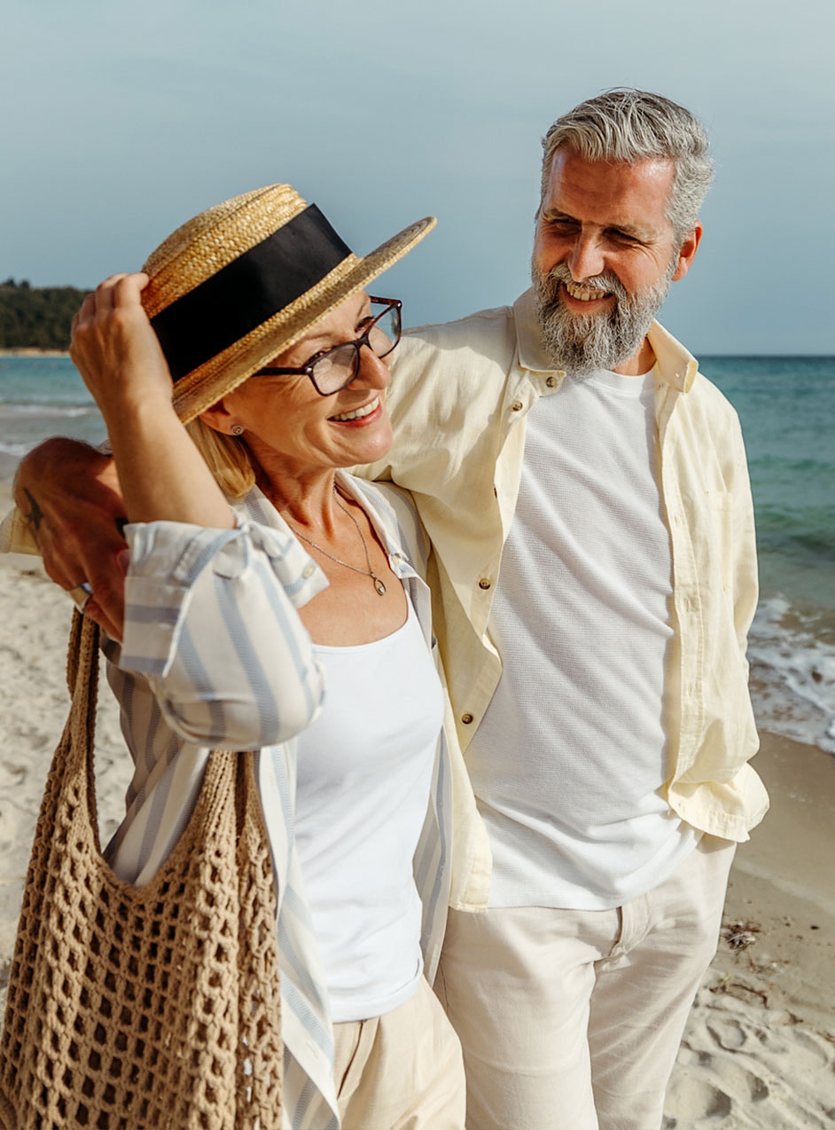 happy older couple on the beach after hormone therapy treatment in Dallas