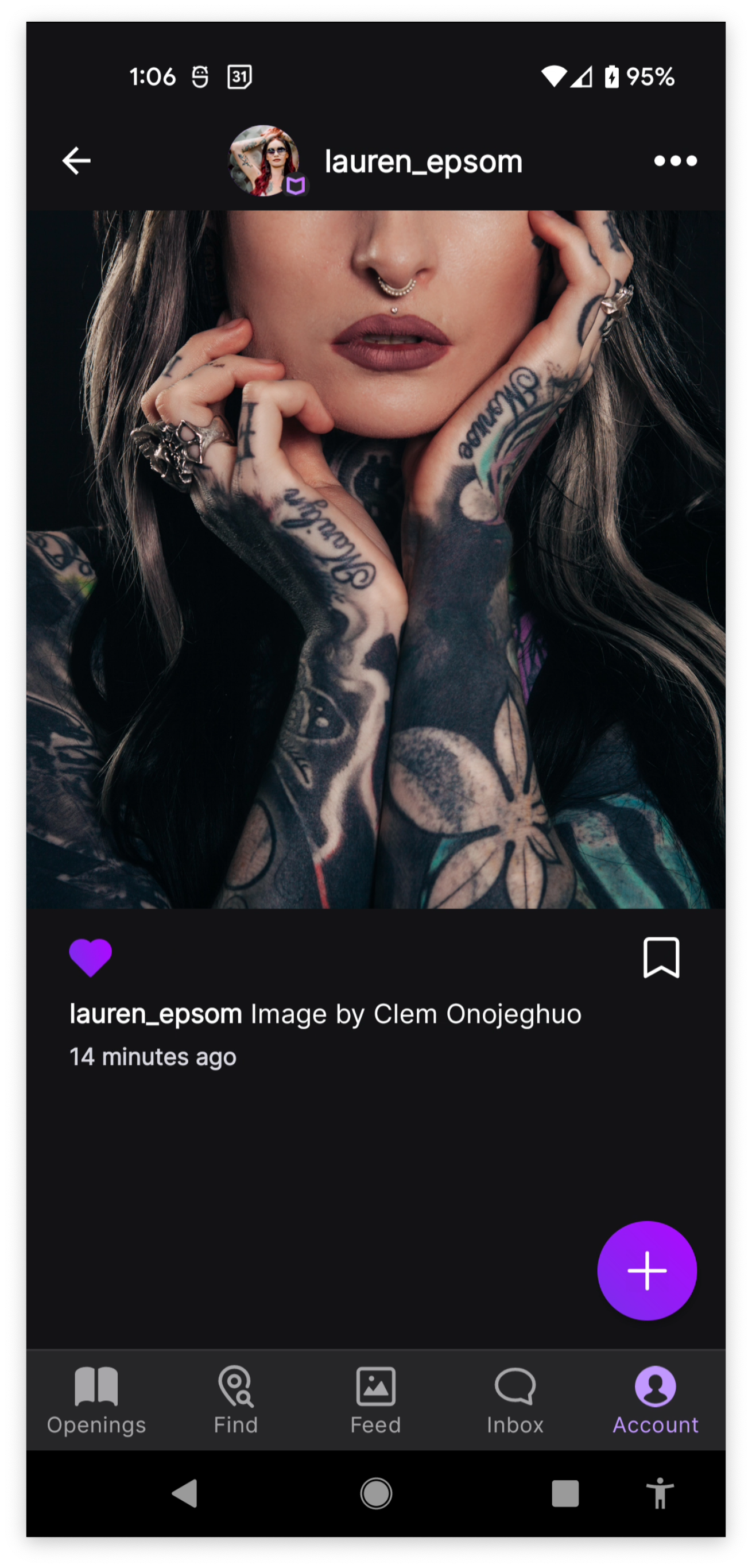Front view of a white woman with sleeve tattoos, blonde hair, dark reddish brown lipstick, and a ring septum piercing. Woman is from a stock photo image by Clem Onojeguo. The image takes up the top half of the screen. A purple heart is filled showing that the user liked the photo. Artist's username is lauren_epsom, a fabricated artist.