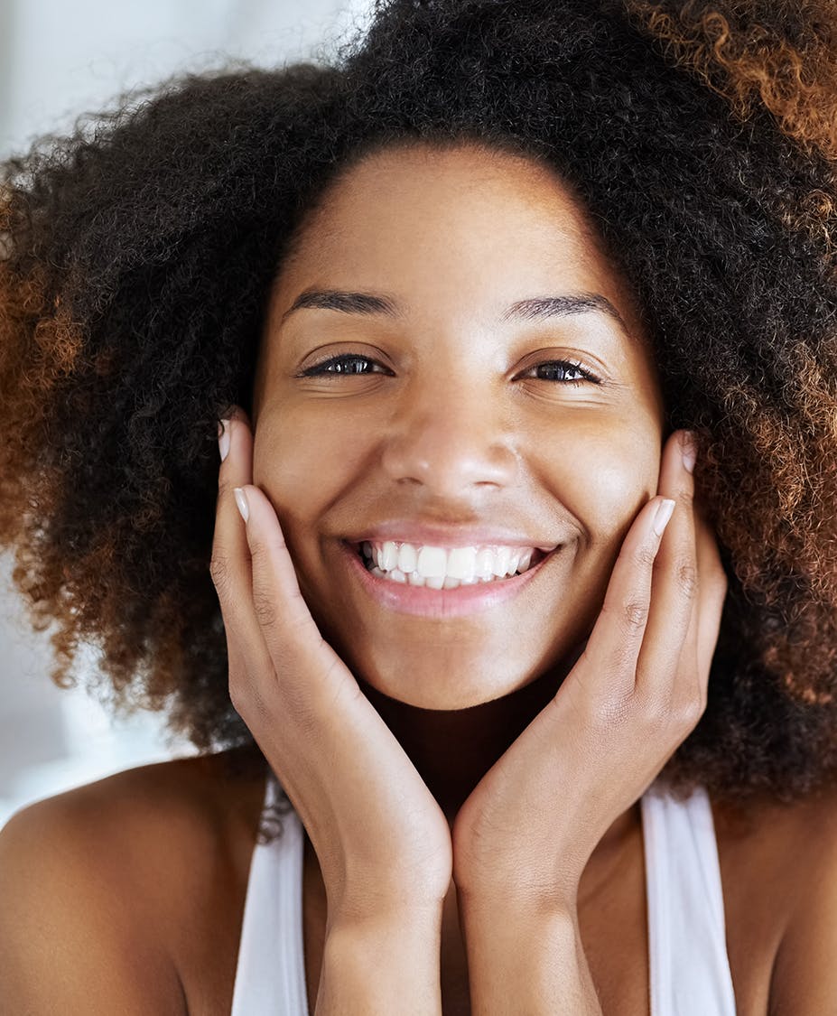 Woman happily holding her face