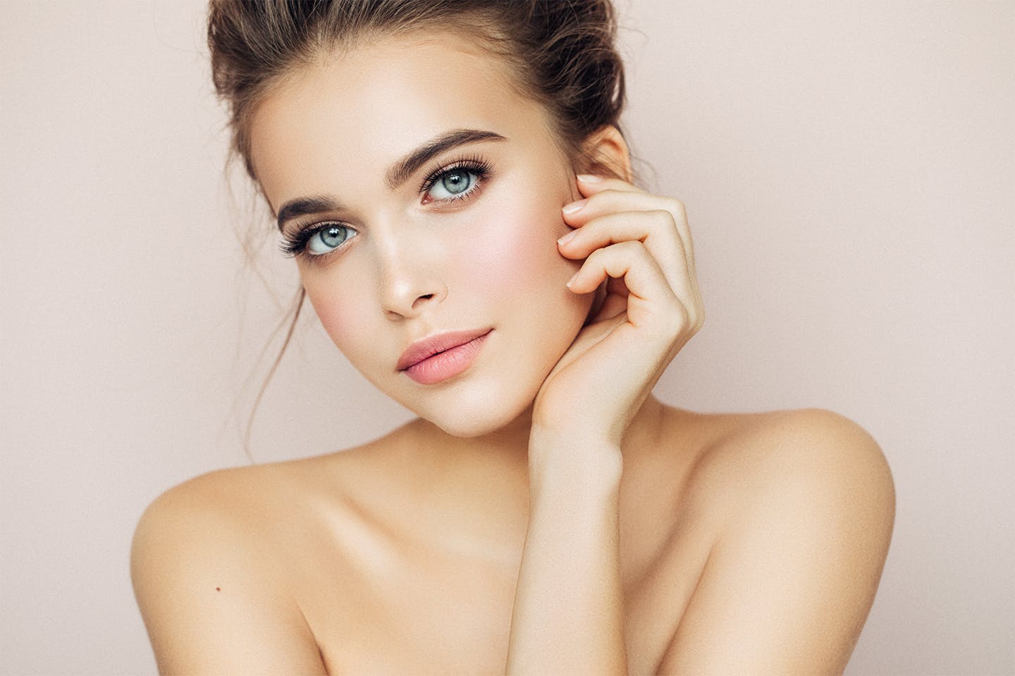 Woman leaning her hand against her face