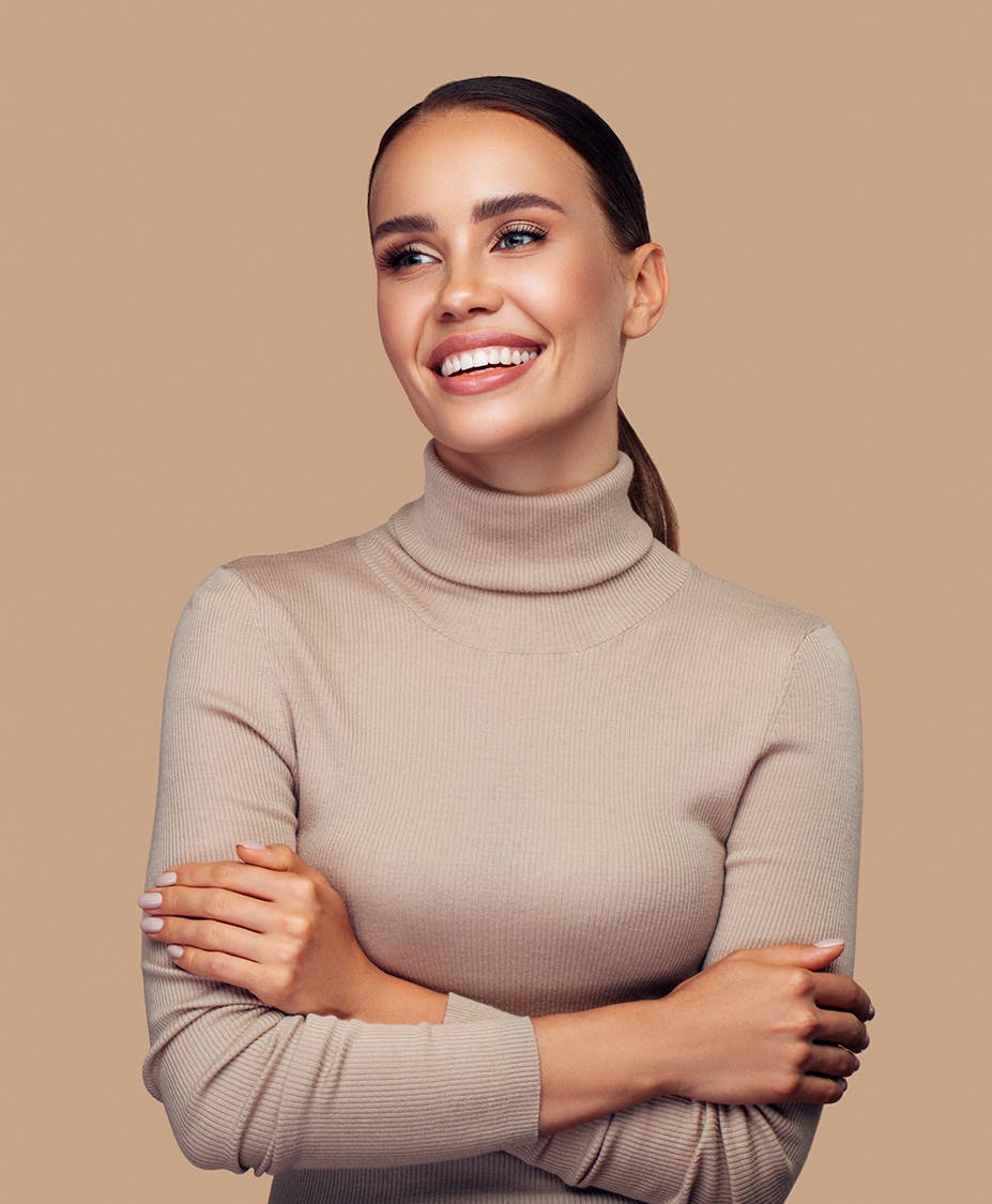 Woman with her hair pulled back in a ponytail while crossing her arms