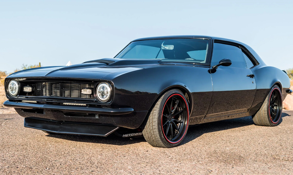 1968 Camaro featuring Universal Pro Series Low Back seats with SPORT-R design including black vinyl, gray suede, and red contrast stitching. Paired with matching rear seat, door panels, center console, and dash pad.