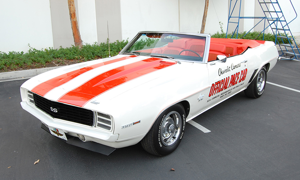 1969 Pace Camaro featuring deluxe style seating with orange vinyl and orange hounds-tooth stooth cloth. Includes matching rear seat, convertible top, door panels, sun visors, center console, and a new carpet kit.