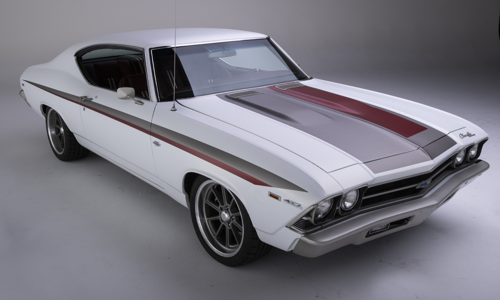 1968 Chevelle featuring Universal Pro Series Low Back seats with SPORT-R1000 design in maroon vinyl with white accents and white contrast stitching. Includes matching center console, steering wheel, door panels, dash pad, carpet kit, headliner, and trunk kit.