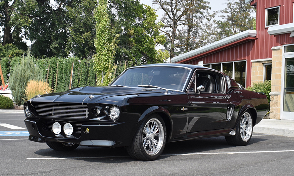 1967 Mustang Fastback with Universal Pro Series High Back seats in SPORT design with black vinyl and white contrast stitching. Includes matching rear seat, center console, dasp pad, and SPORT-R door panels. 