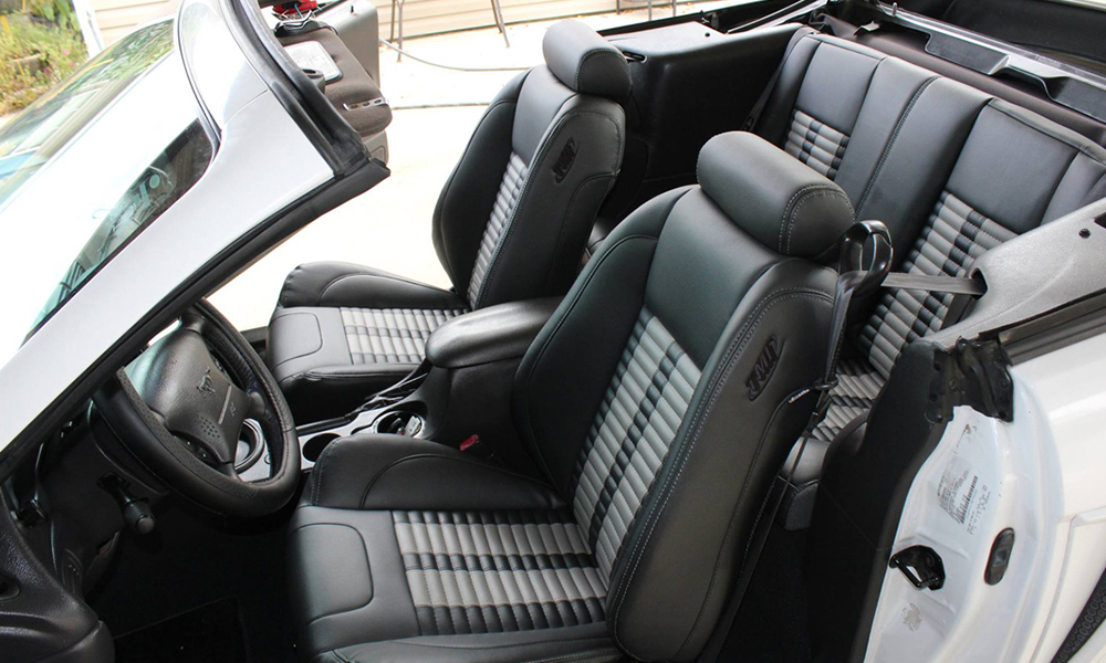 2003 Mustang featuring standard replacement SPORT-R500 upholstery in with black and gray vinyl and gray contrast stitching. Includes matching rear seat.