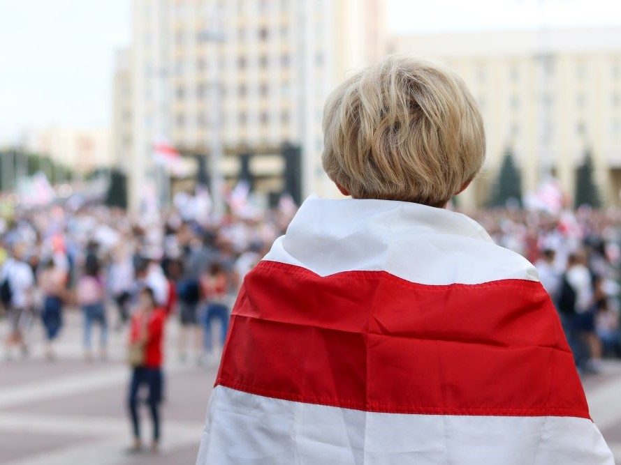 A peaceful protester wearing a flag