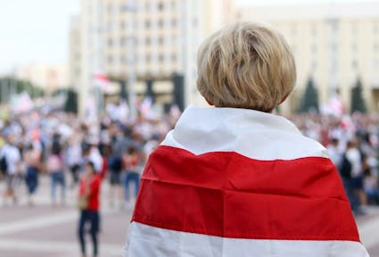 A peaceful protester wearing a flag