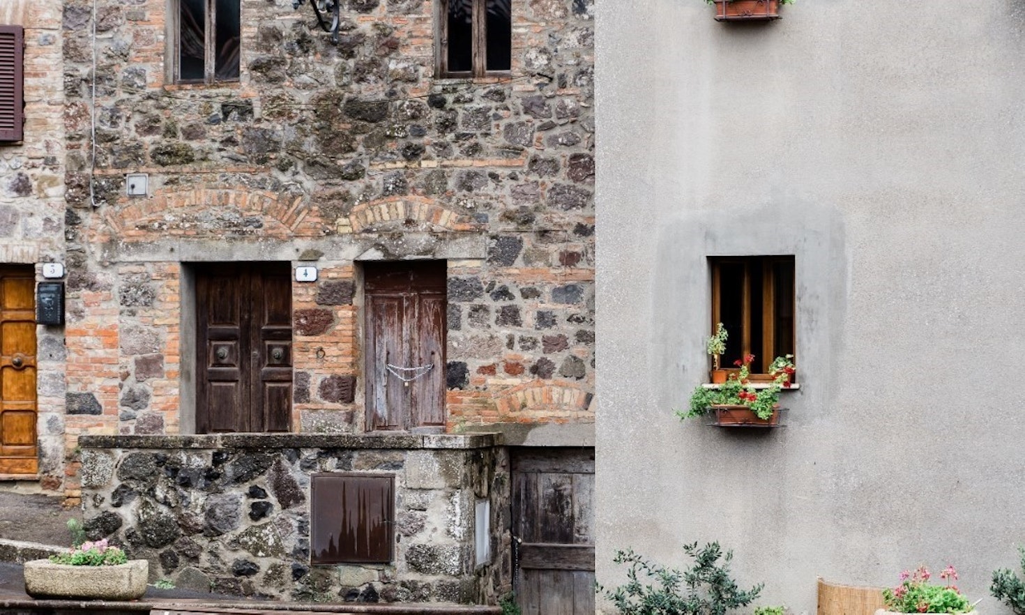 person looking out of old stone house window