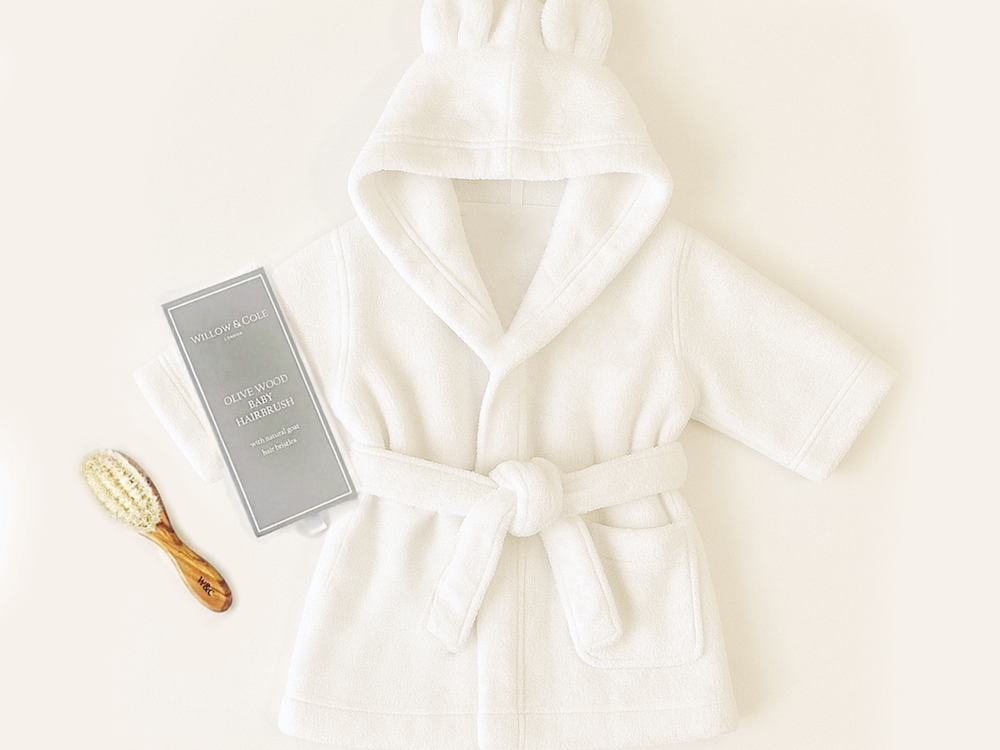 A luxury newborn gift set with a soft Hydrocotton robe and natural olivewood baby brush, beautifully packaged in a Willow & Cole gift box.
