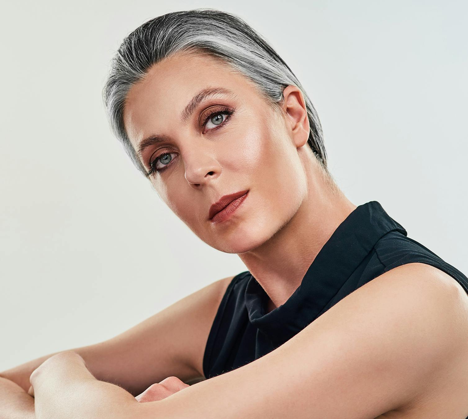 Beautiful middle aged woman wearing makeup with a serious facial expression