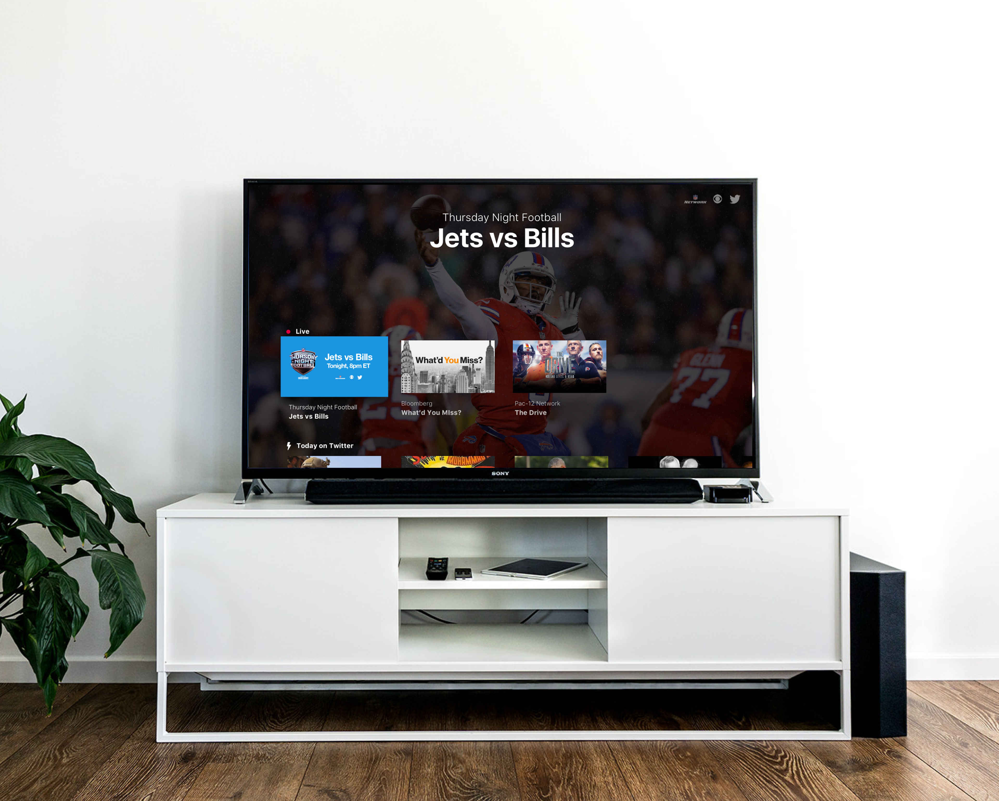 Large TV on TV stand showing the Twitter  (X) TV app