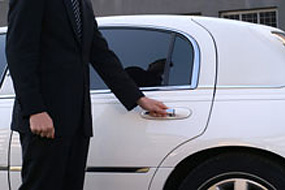 Person opening car door for patient