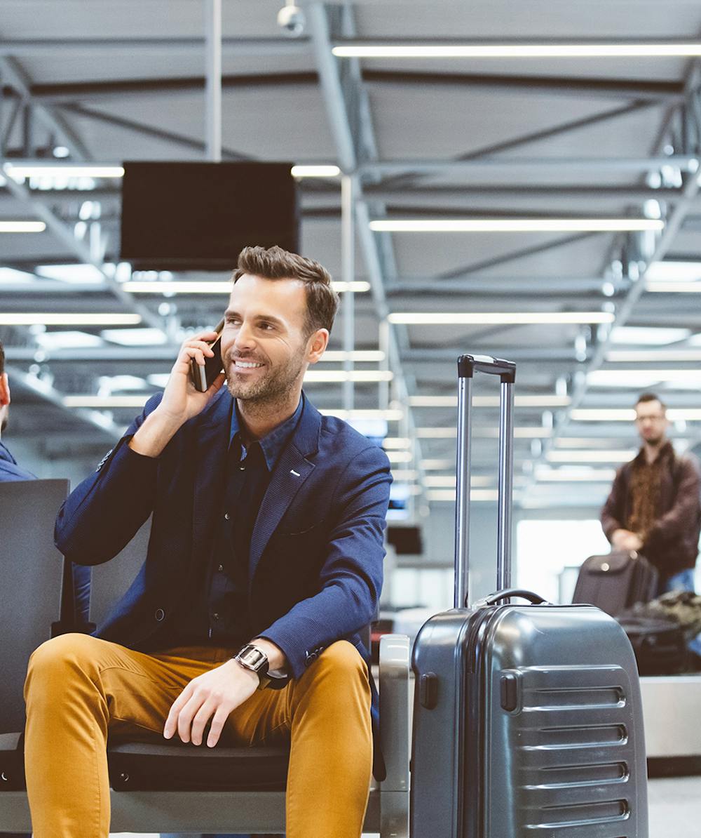 Man sitting in airport and talking on the phone