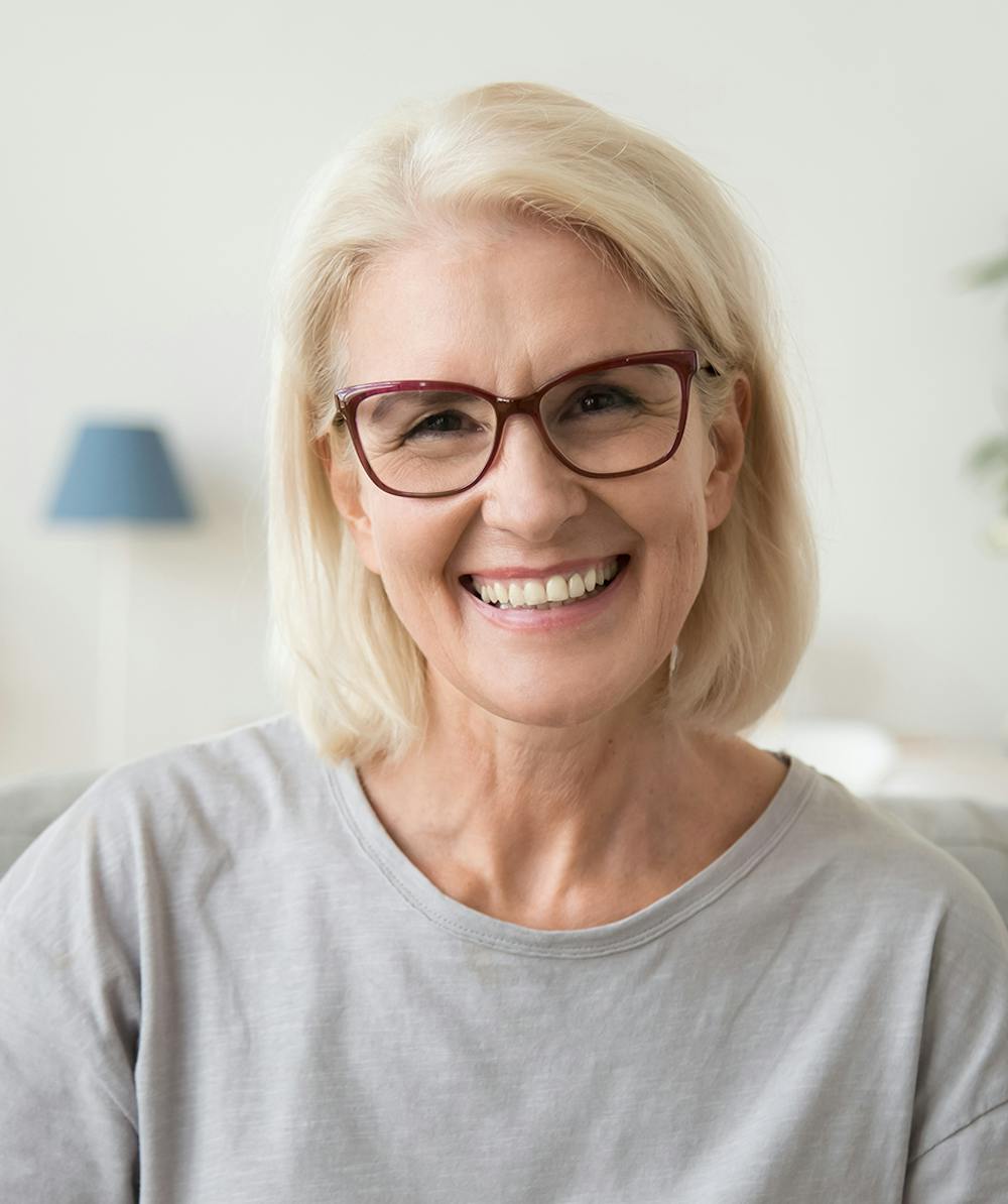 Smiling woman that is sitting in waiting area