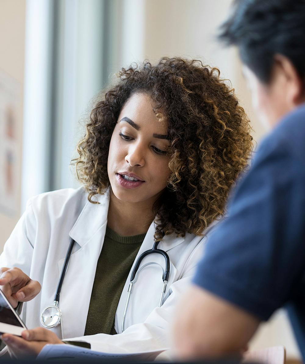 Doctor showing patient their information on phone